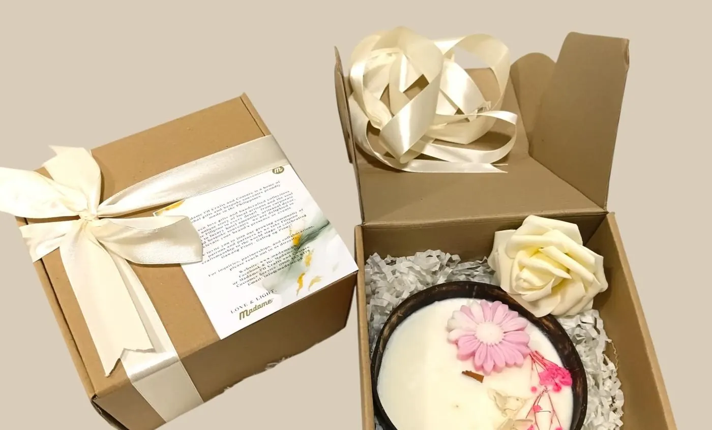 Open kraft gift box with a coconut bowl candle